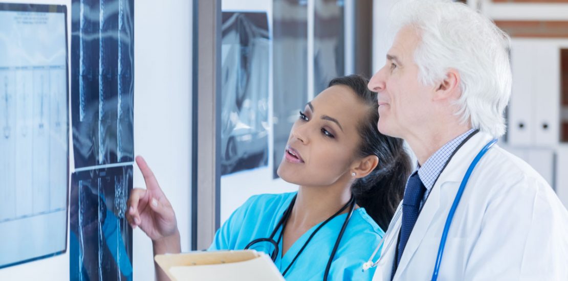 Allied health worker reviewing X-rays