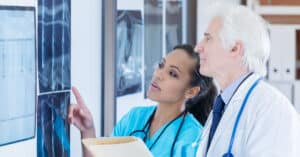 Allied health worker reviewing X-rays