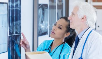 Allied health worker reviewing X-rays