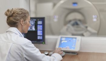 Allied health career radiologist looking at CT