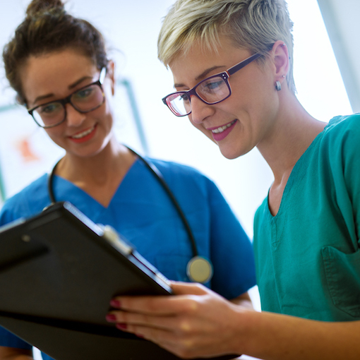 Two allied health career professionals reviewing documents