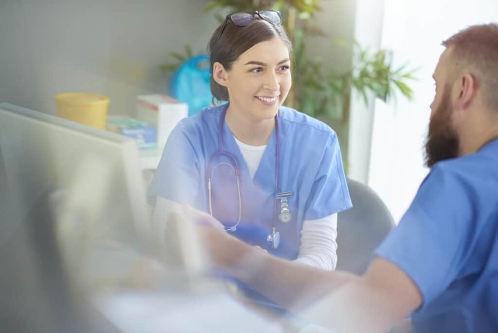 Two nurses talking at a desk