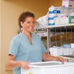 Nurse collecting supplies from a cart